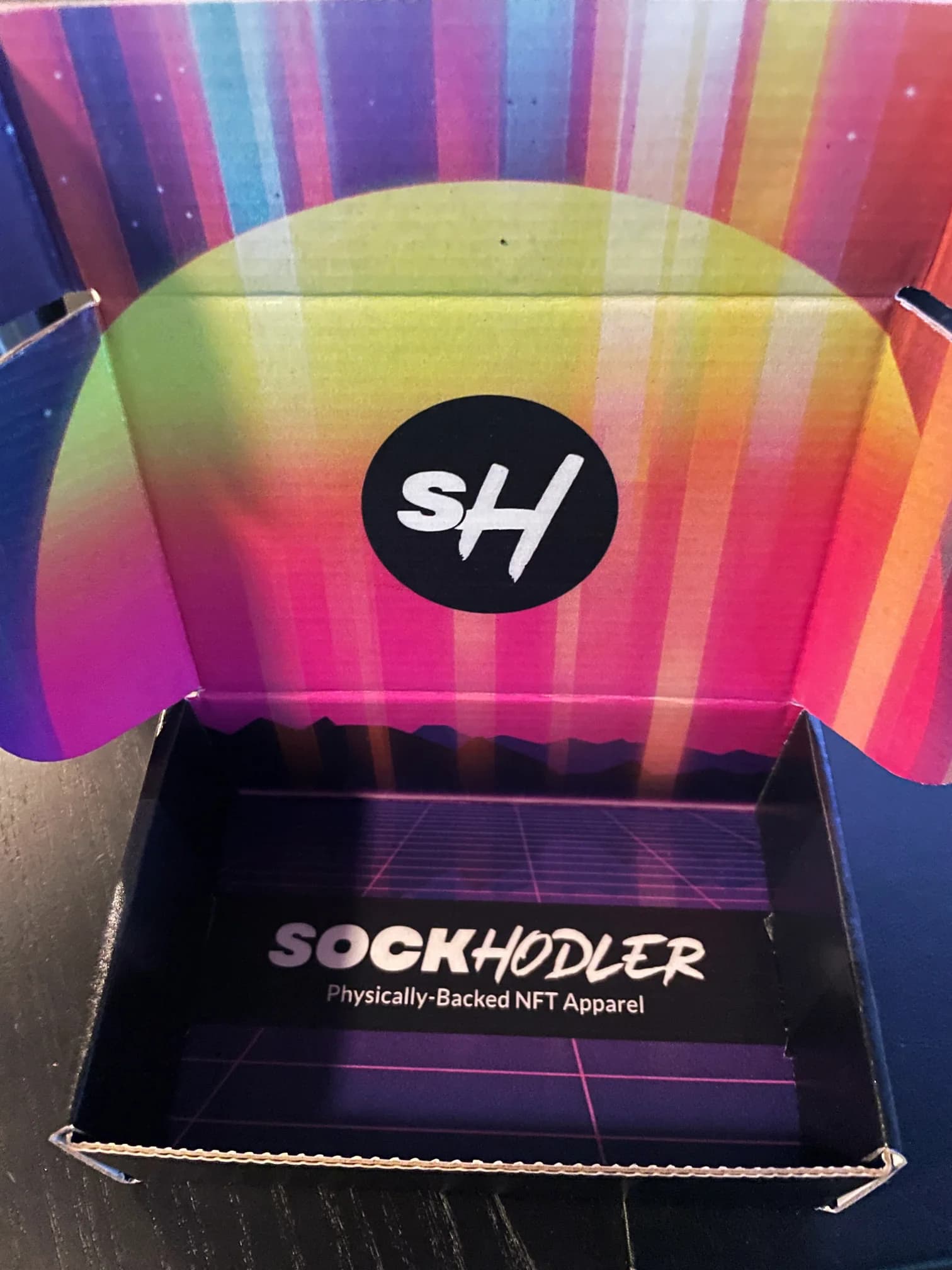 Open box with colorful interior featuring SOCKHODLER branding.