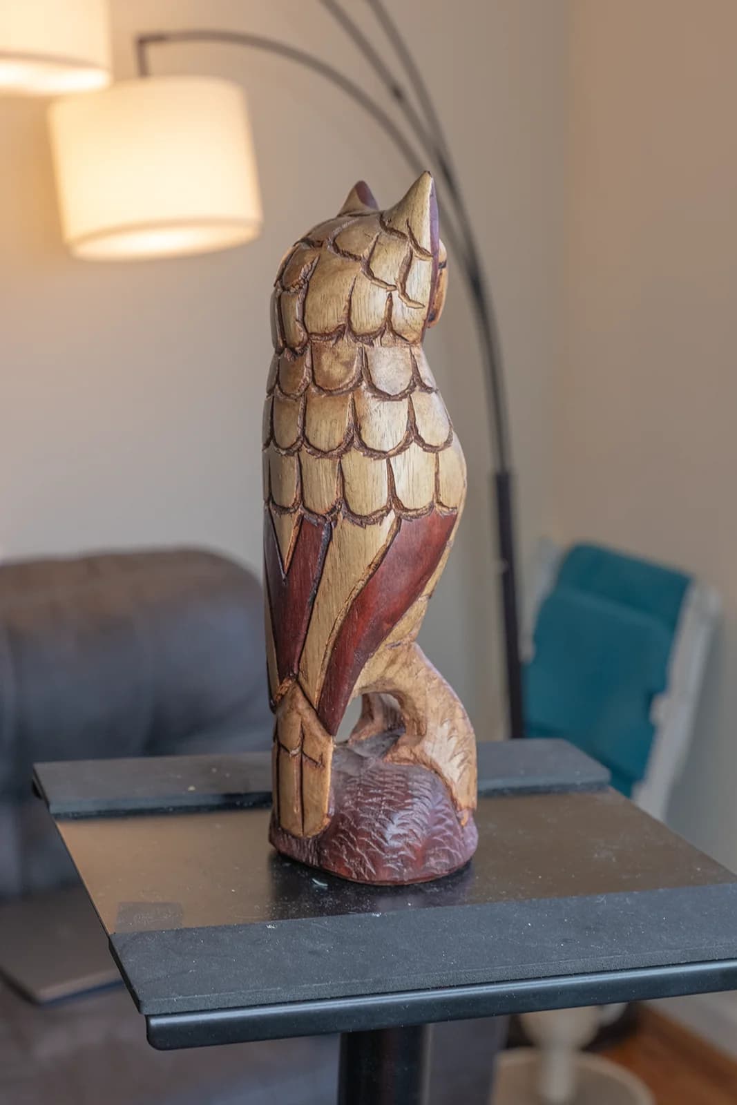 Beautifully carved wooden owl sculpture, showcasing intricate details and warm colors in a cozy indoor setting.