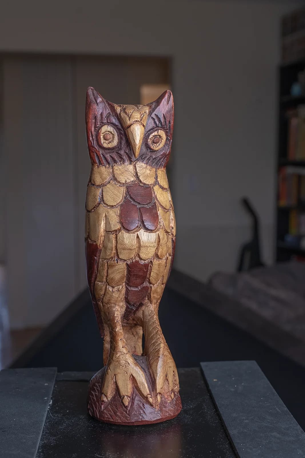 Handcrafted wooden owl sculpture with intricate detailing and natural colors