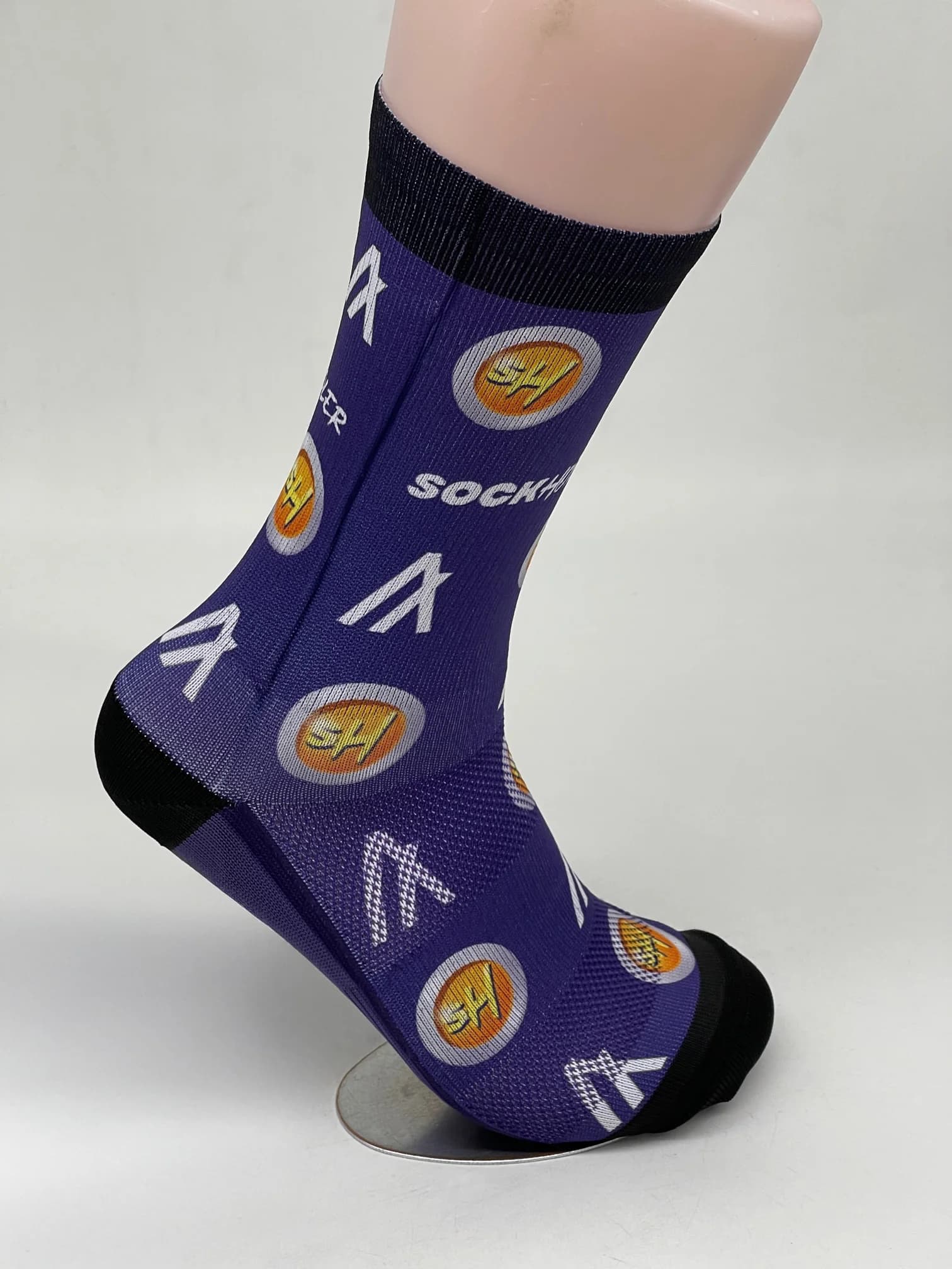 Purple socks with logos and text 'SOCKHODLER' displayed on the side.