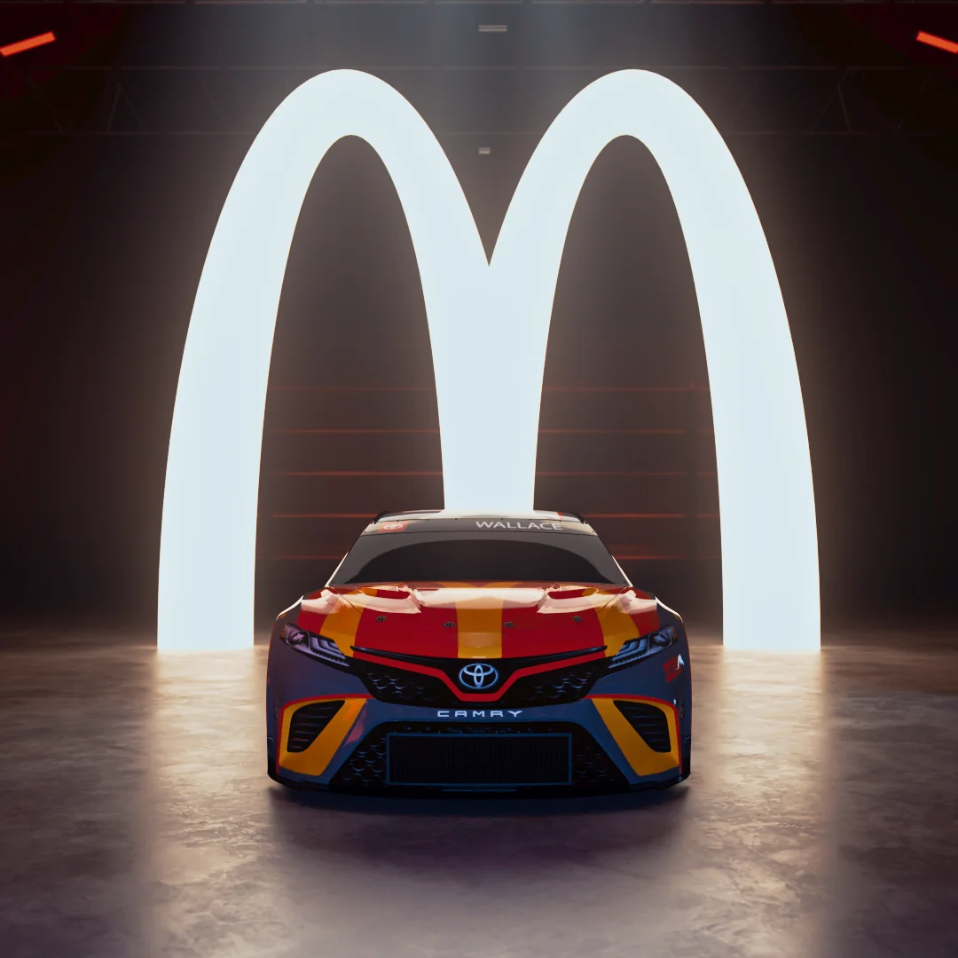 Toyota Camry race car with McDonald's branding displayed in a studio setting.