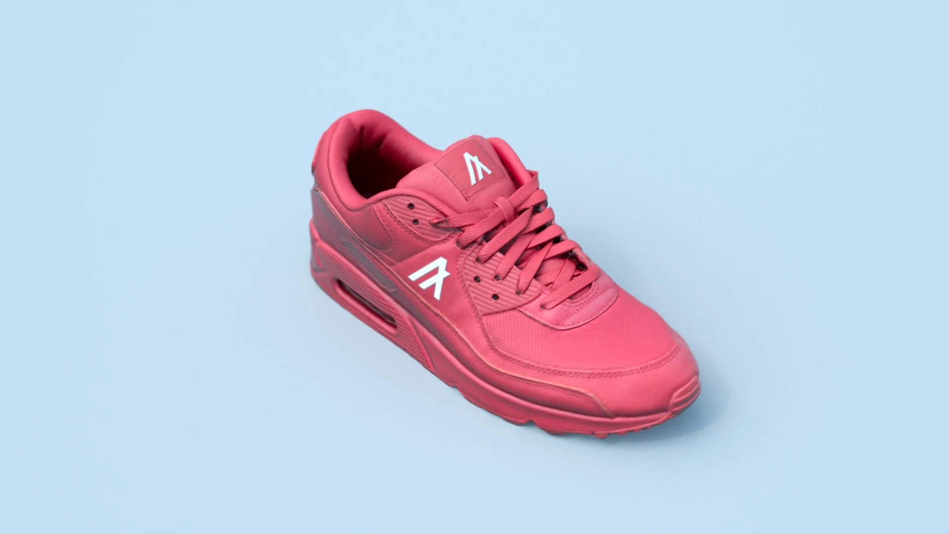Bright red sneakers with white accents on a blue background, stylish and modern design.