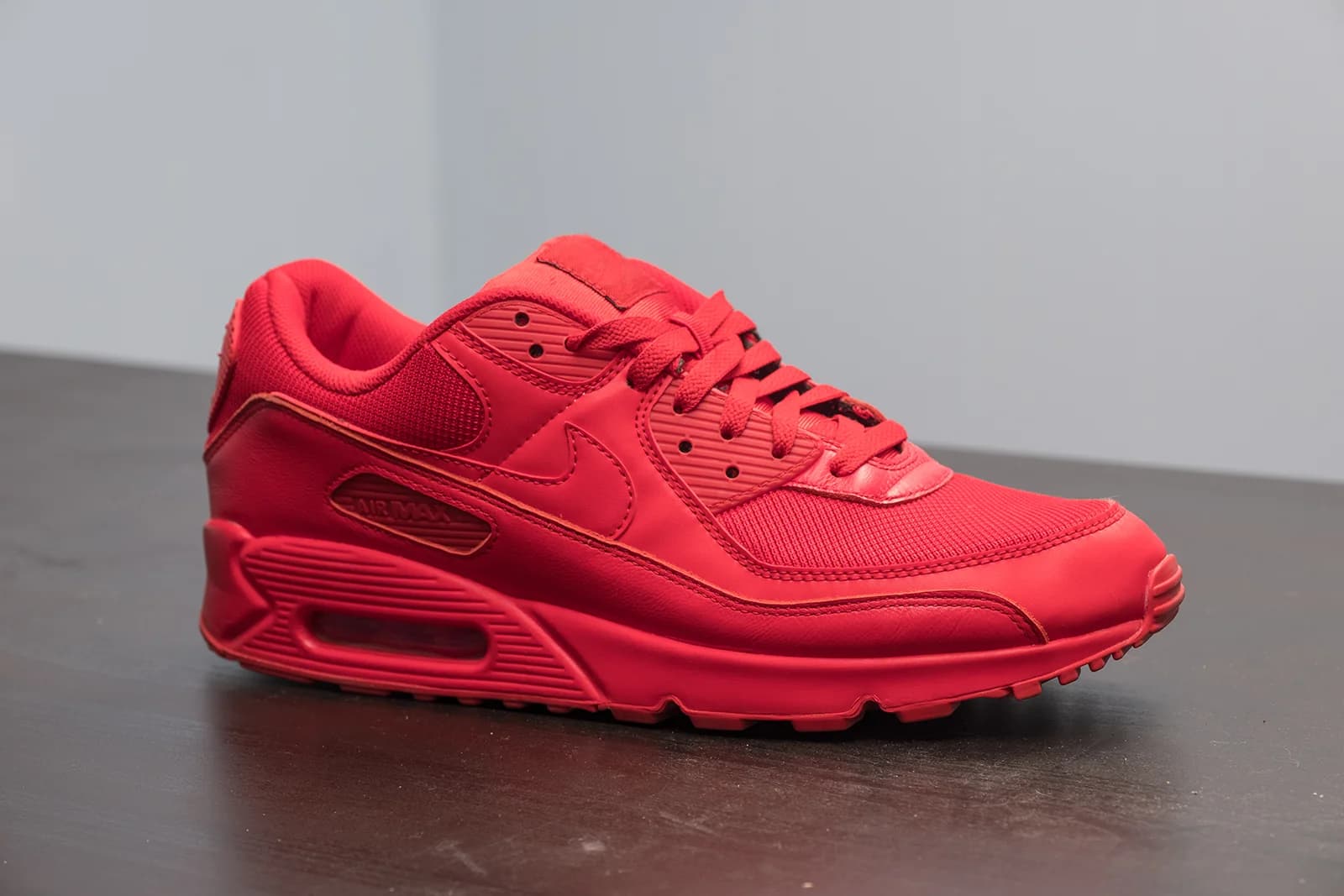 Classic Nike Air Max shoe in vibrant red, showcasing a sleek design and comfortable fit.