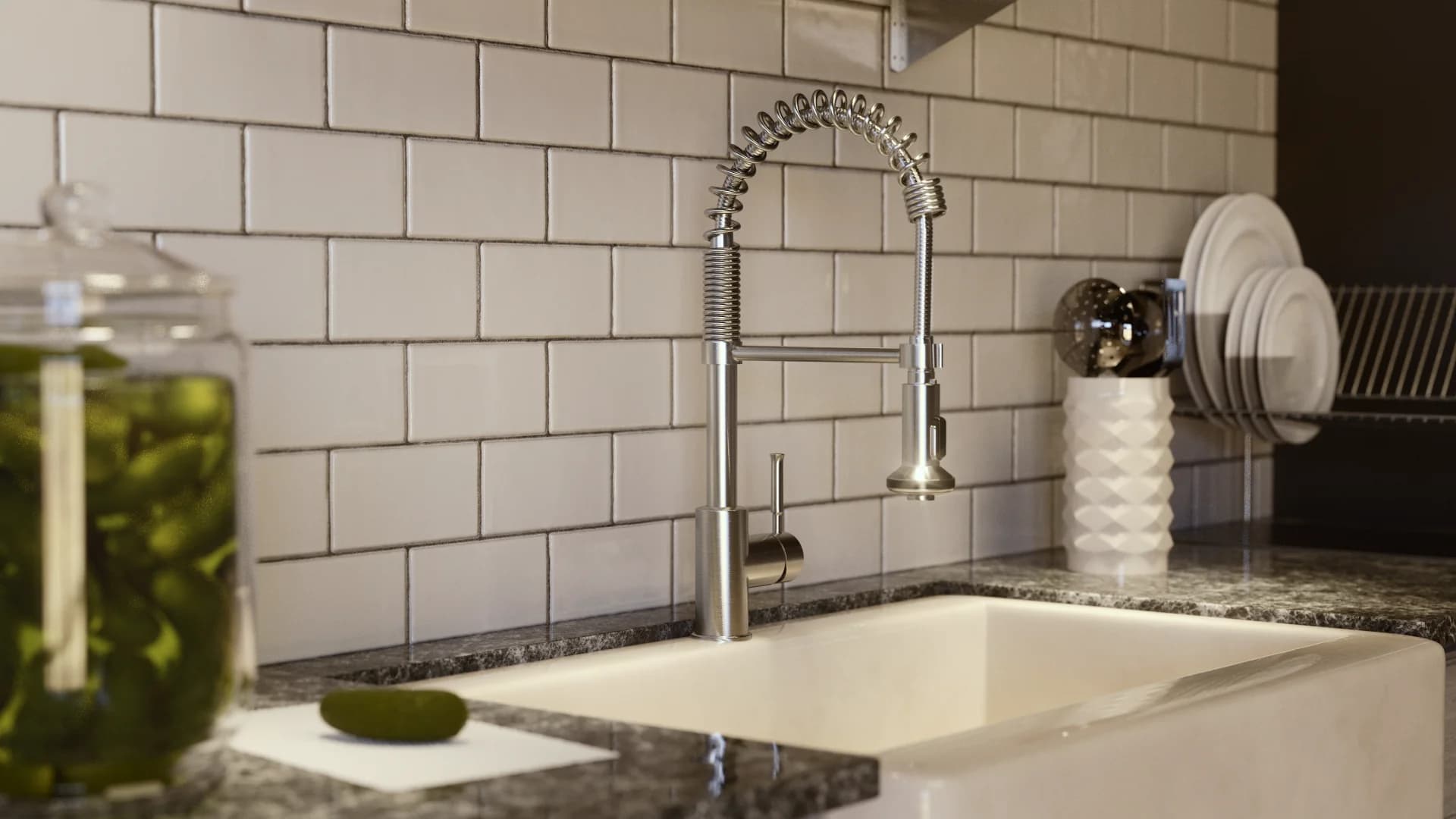 Modern kitchen sink with stainless steel faucet and trendy backsplash, featuring decorative jars and plates.